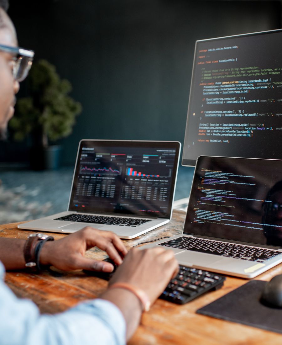 a web developer writing a custom coded website on a computer