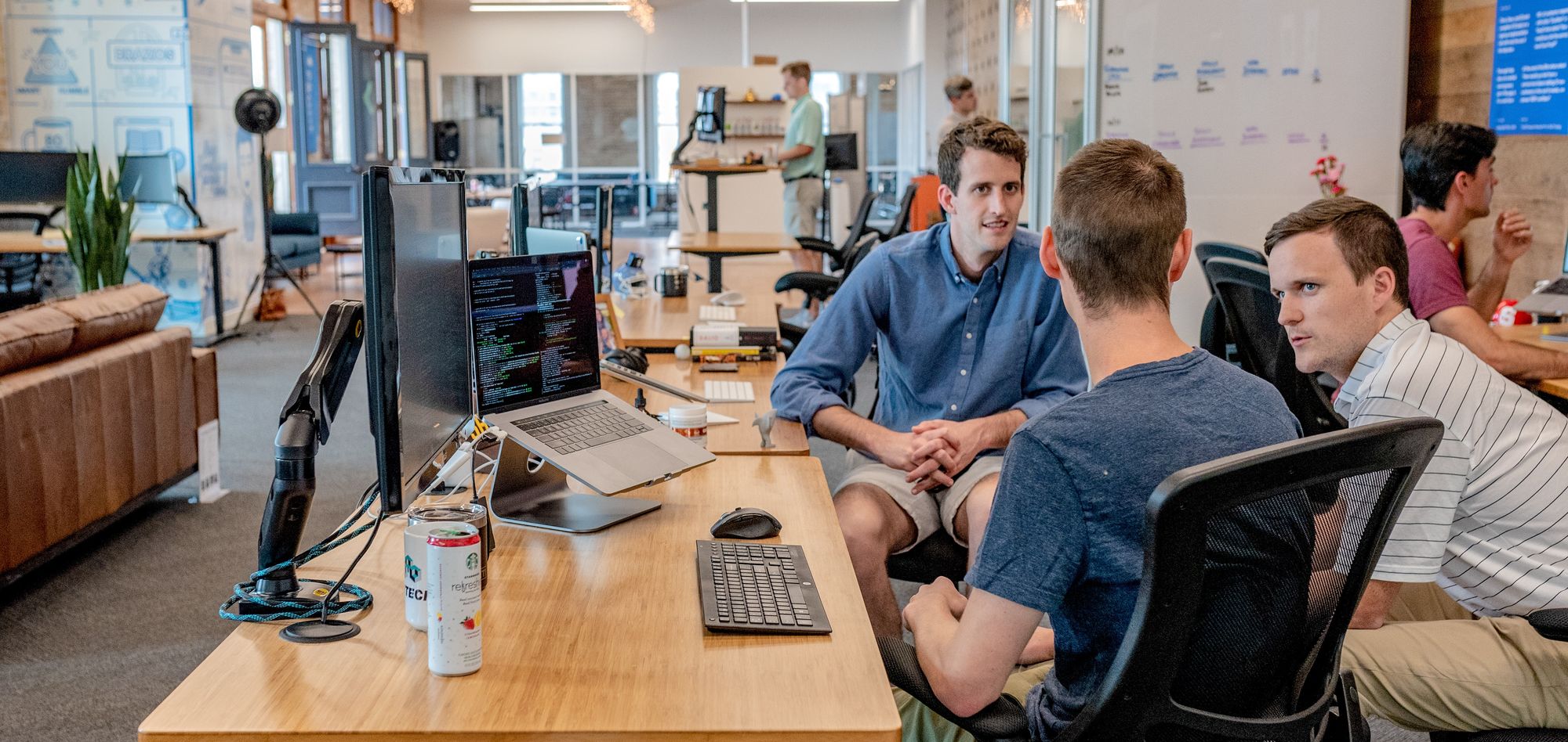 A group of developers sitting back in their chairs, chatting