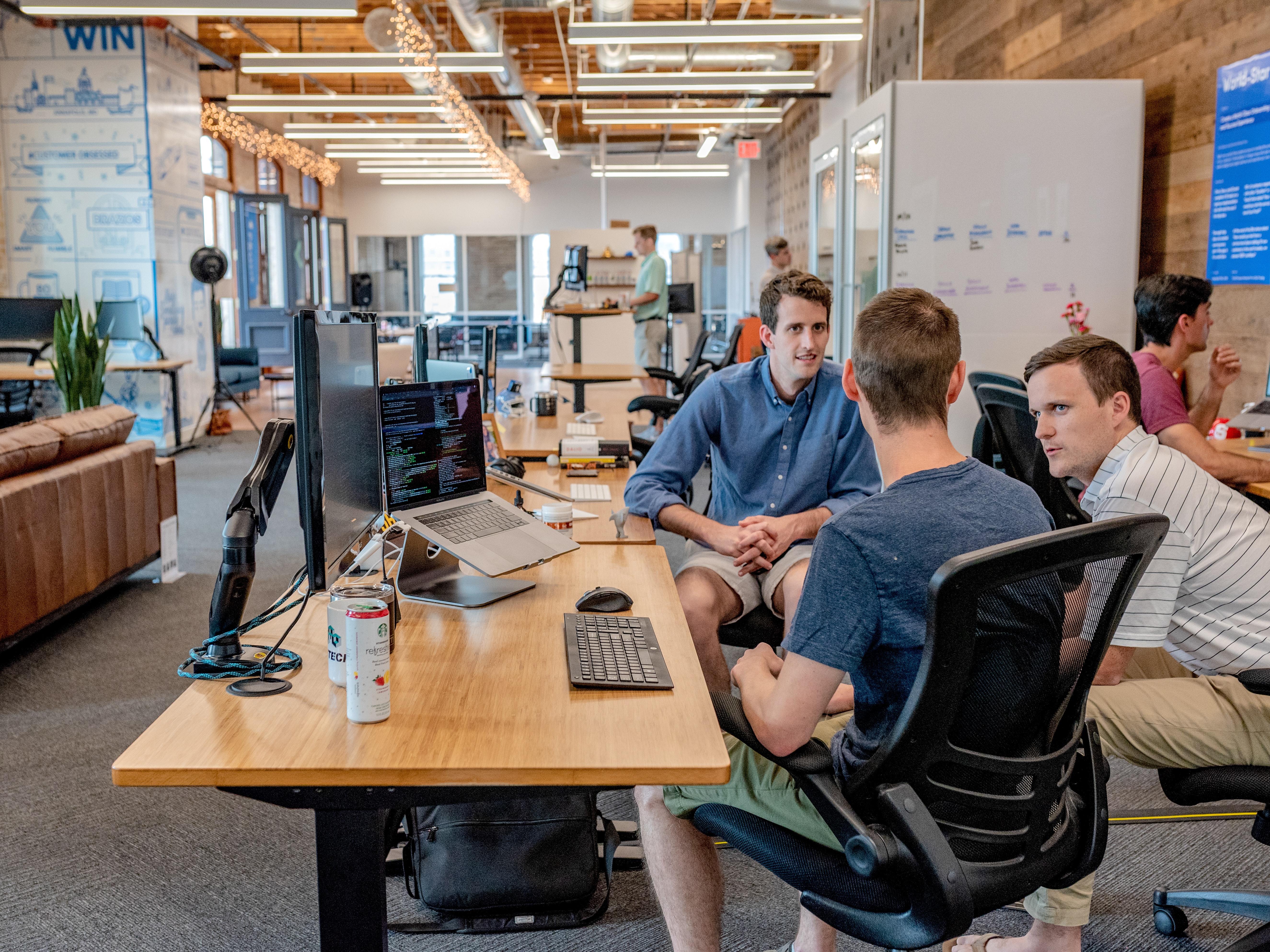 A group of developers sitting back in their chairs, chatting