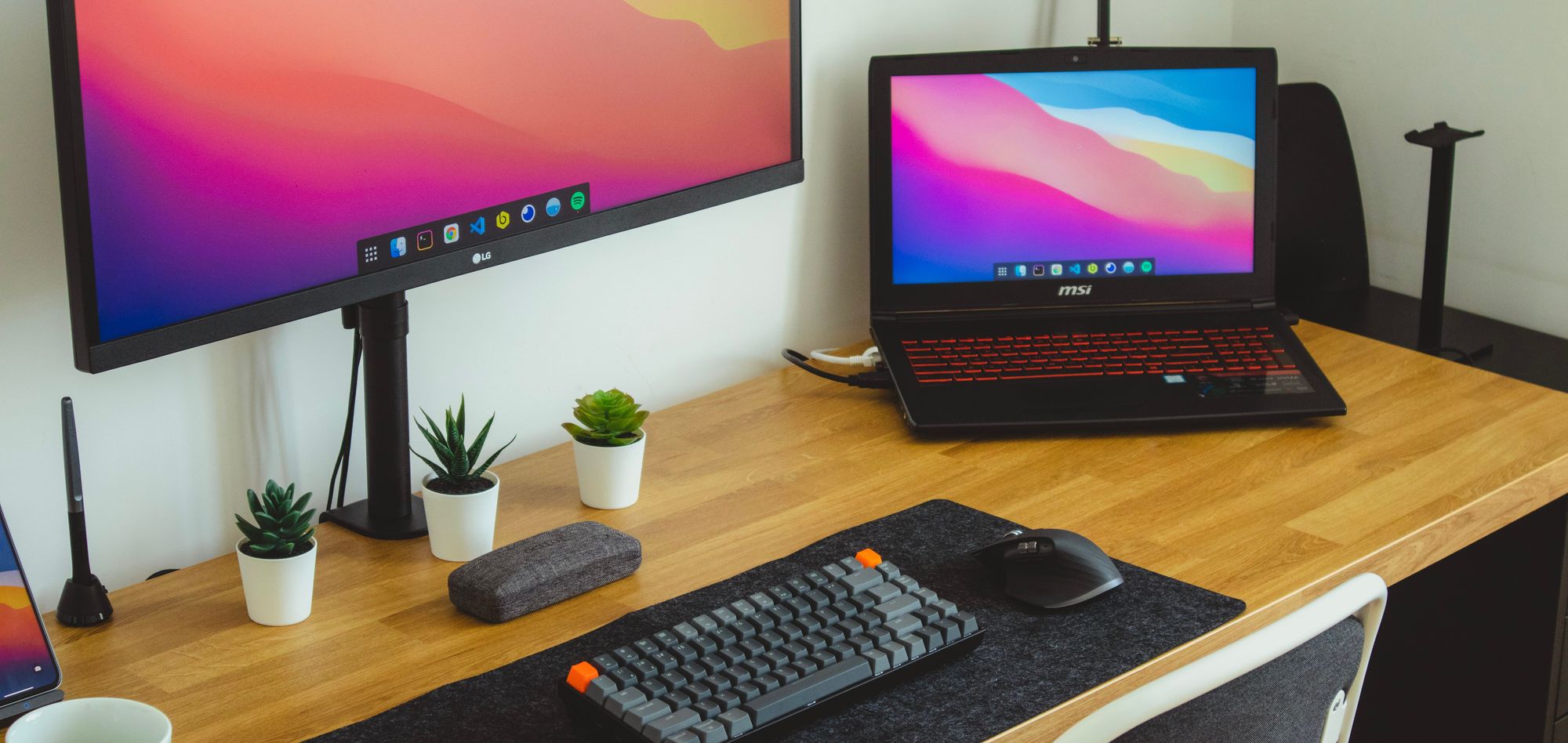 A website designers workstation, including a laptop, monitor and keyboard