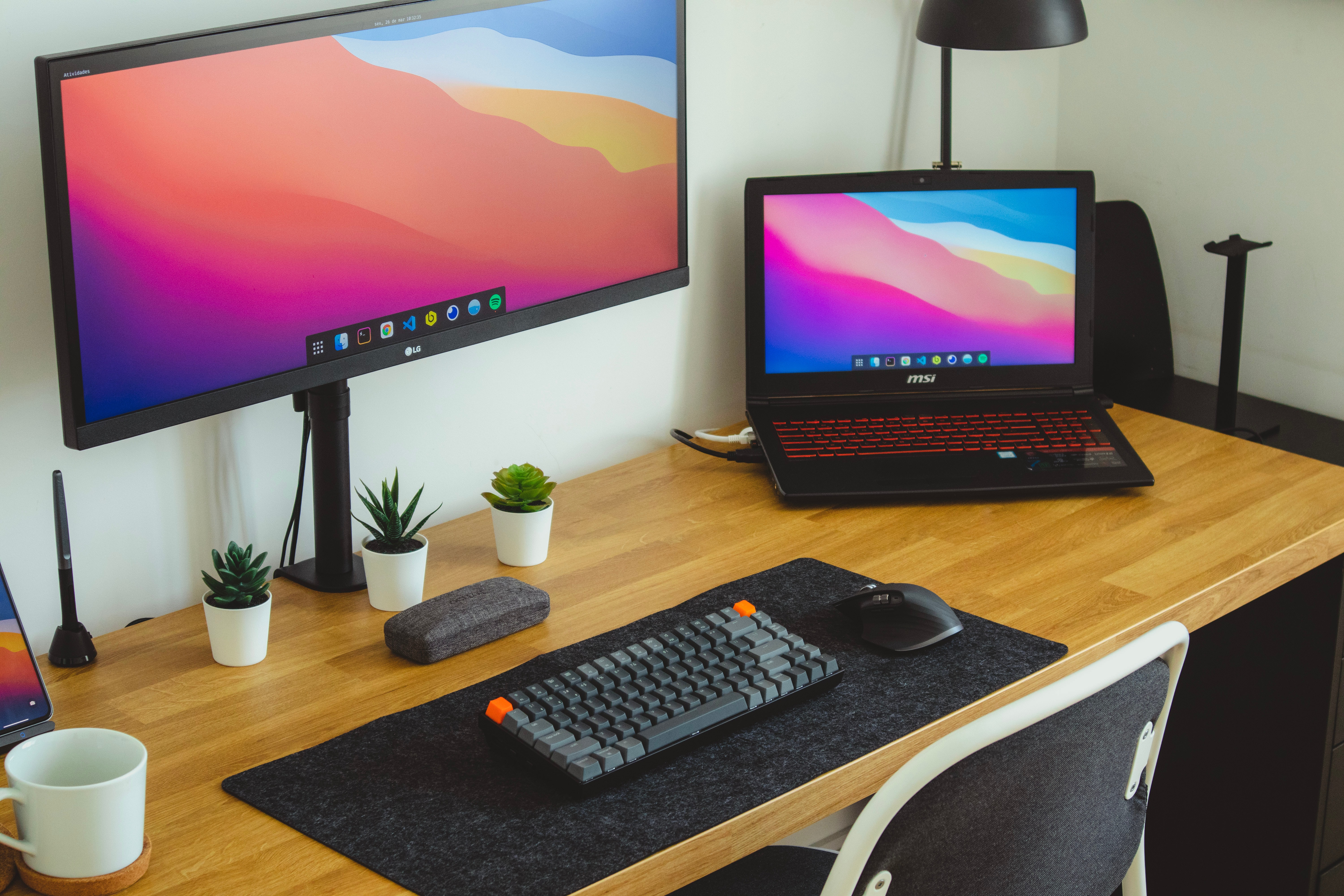 A website designers workstation, including a laptop, monitor and keyboard