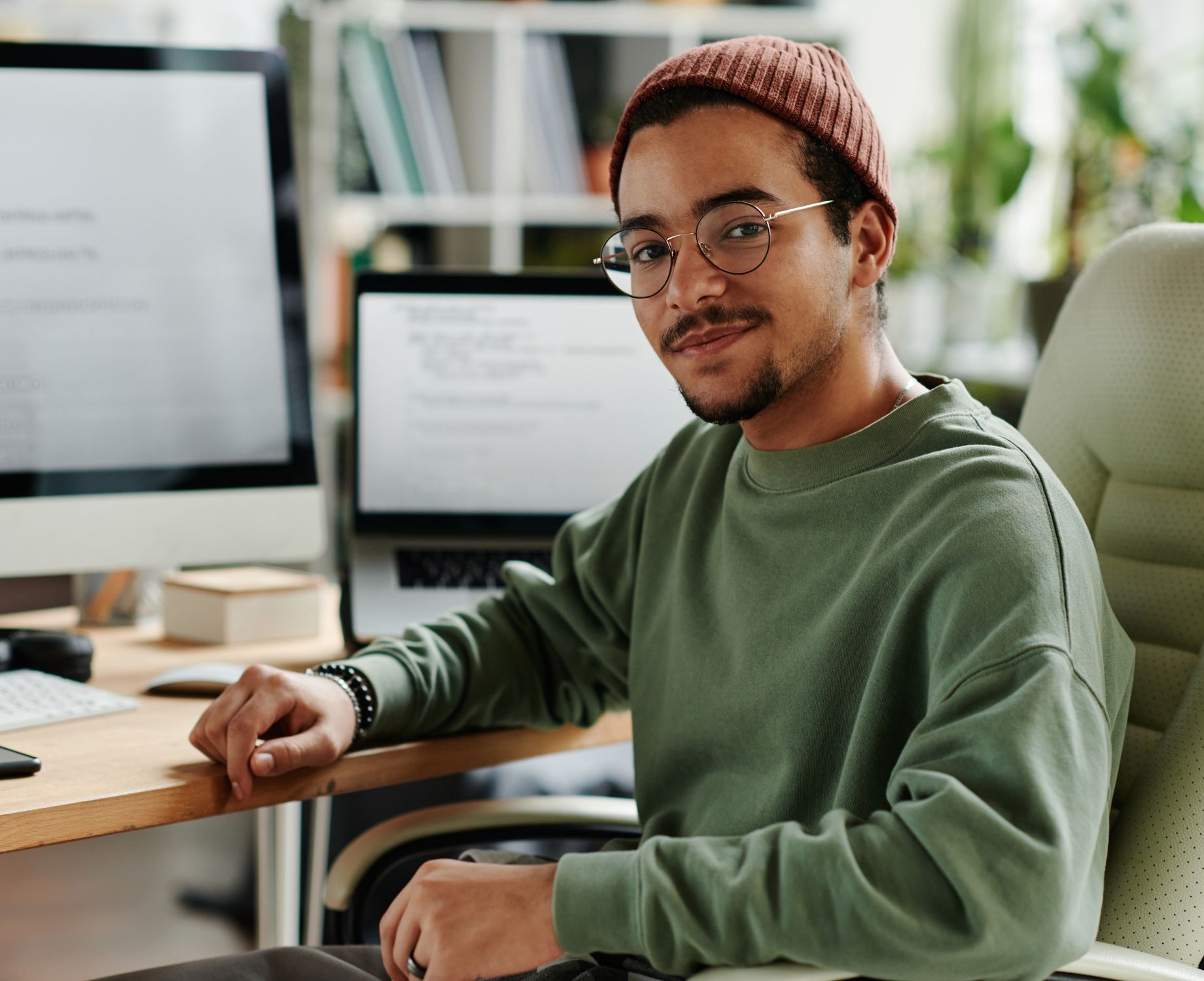 a happy working man lookng at his computer