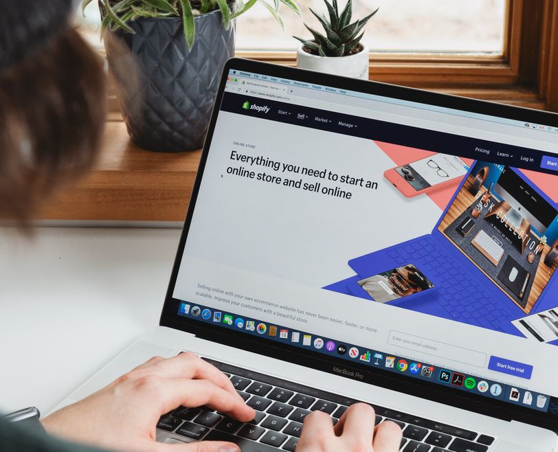 someone on their laptop on the shopify website