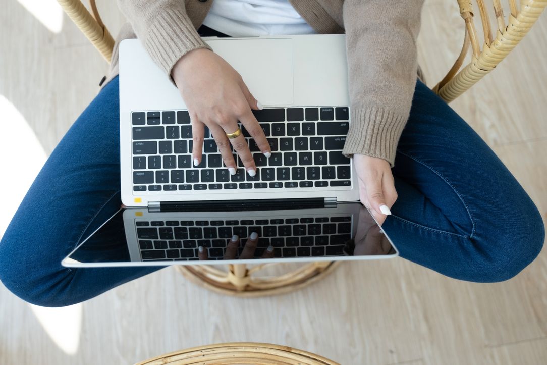 A top-down view of somebody typing copy up on a laptop