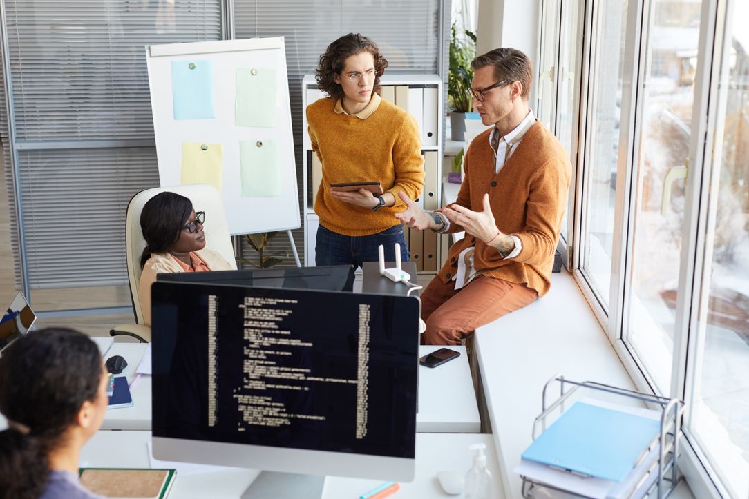 A web agency partnership meeting taking place in a white room