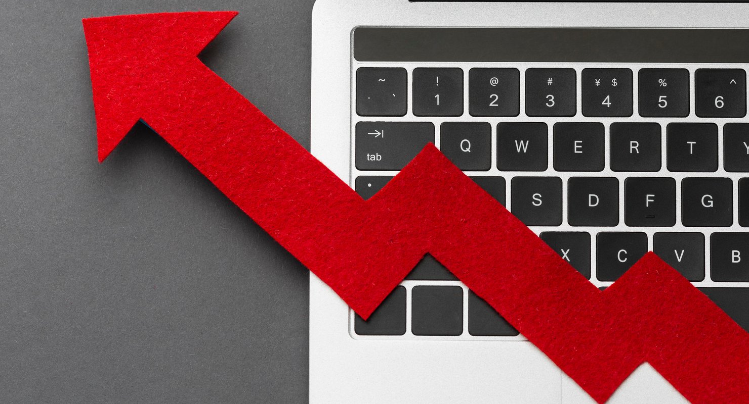 Red arrow going upwards on a laptop keyboard