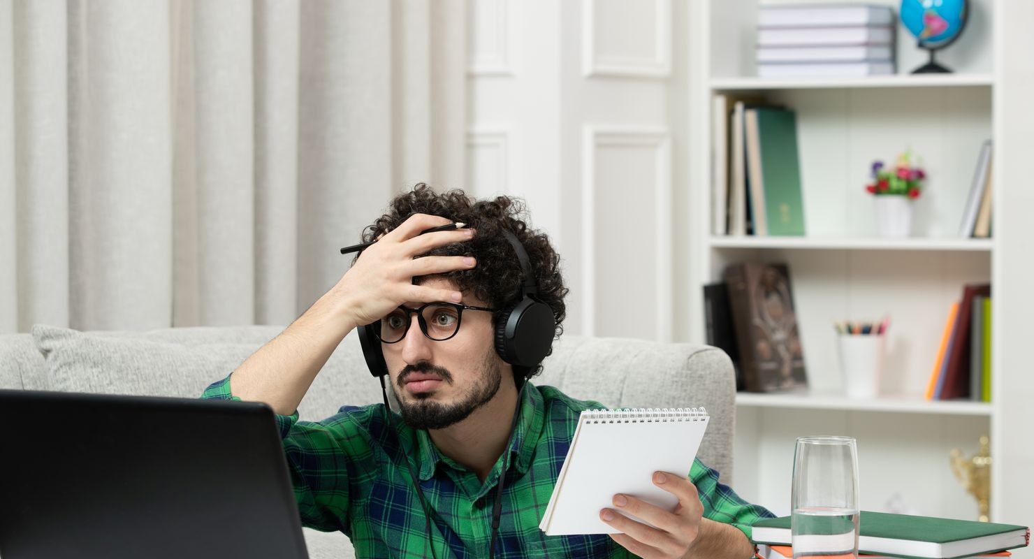 Developer working on computer holding his head in shock