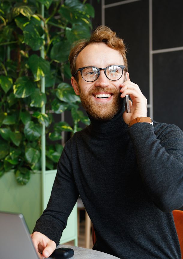 a man happily on the phone to customer support