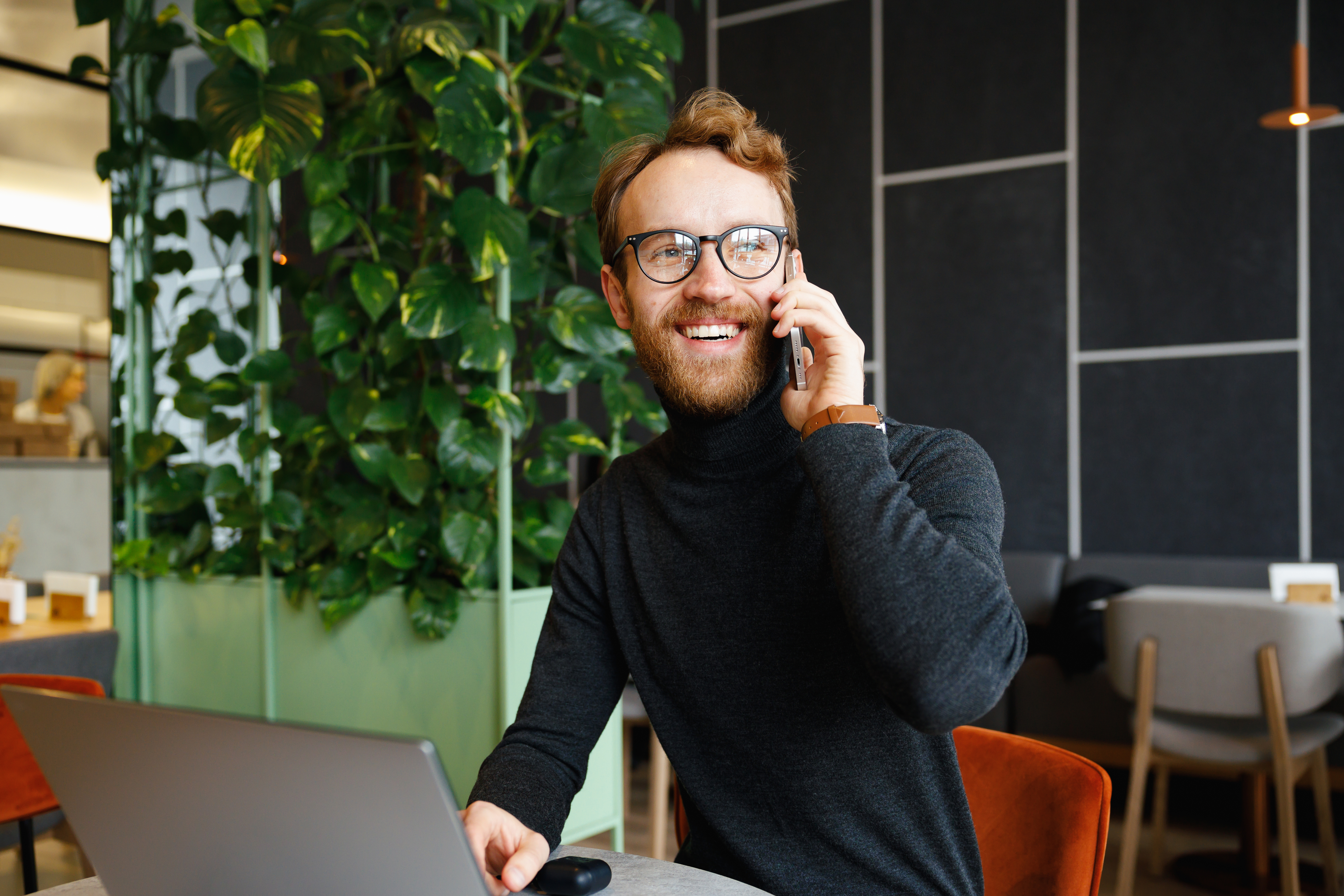 a man happily on the phone to customer support